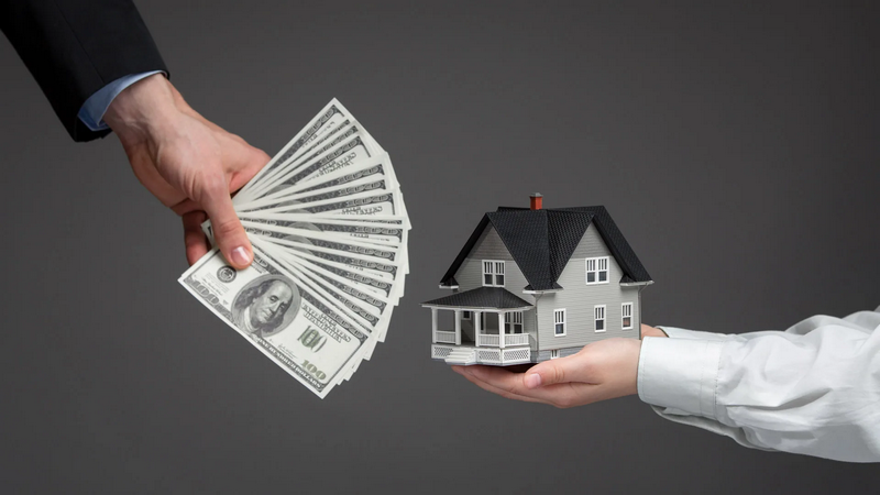 A person is holding a stack of hundred-dollar bills while another person is holding a small model of a house.