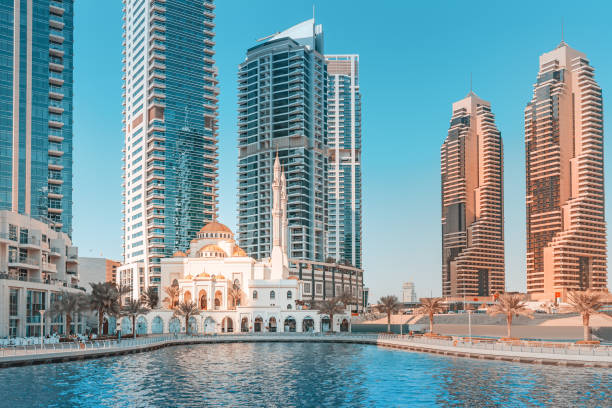 Modern high-rise buildings by the waterfront, symbolizing real estate development and considerations for land buying.